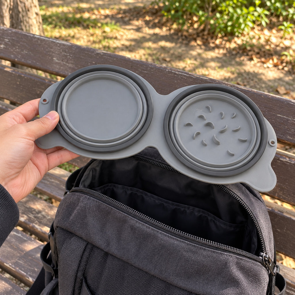 The double bowl folded flat in one hand above a backpack