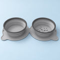 Grey collapsible double pet bowl on a mist-blue background