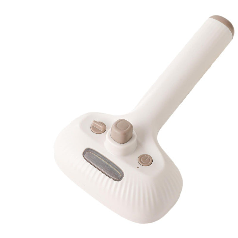 Tuft & Tidy Mist Grooming Brush in ivory, showing the water window and buttons