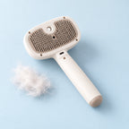 Tuft & Tidy Mist Grooming Brush in ivory on a mist-blue background with a tuft of released fur